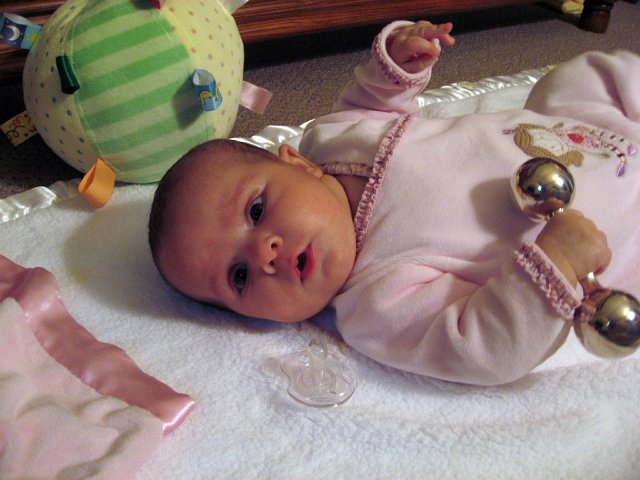IMG_2857b.jpg - Gripping and shaking one of her rattles ...