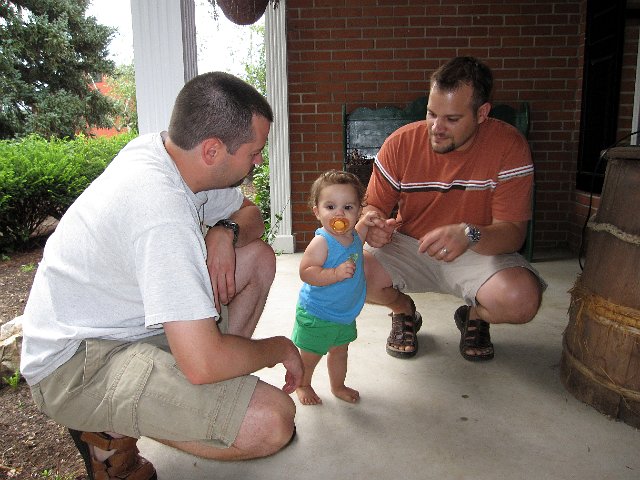 IMG_9200b.jpg - Catherine is strutting her stuff on the front porch with her Dad and Uncle Tom.
