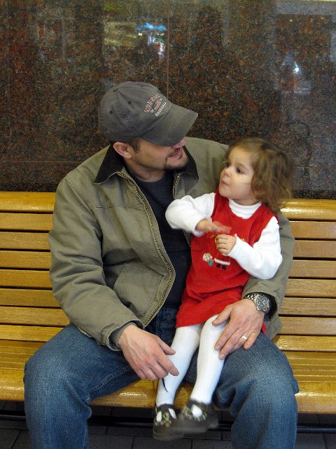 IMG_2200b.jpg - Catherine's visit with "Santa" at the mall.  Apparently, Daddy's was the ONLY lap she wanted to sit on!