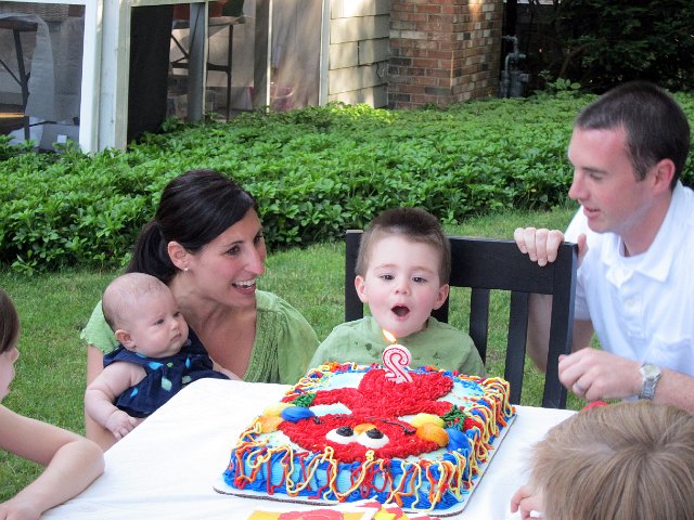 IMG_1659b.jpg - Here's the birthday boy, Rylan and his family (little sister Regan, Mom Deanna and Dad Matt) and we can't forget Elmo!