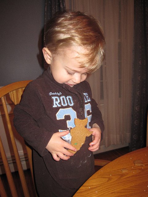 IMG_7533.jpg - Nathan is wearing his poor gingerbread person as a result of leaning onto the table to reach something, ugh!