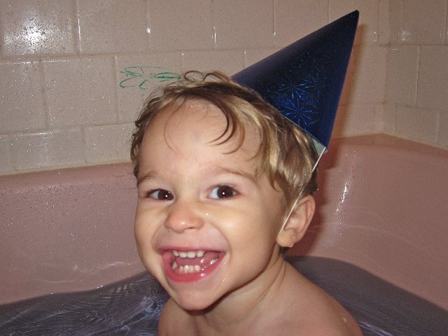 IMG_7818.jpg - Purple water in the tub, crayon writing on the walls .. sounds like any other bath night, except this time there are party hats too!