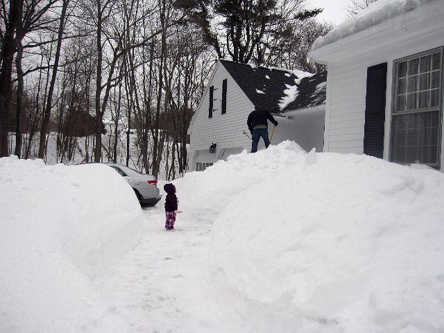 IMG_2826b.jpg - Catherine is admiring Daddy who is hard at work trying to locate our front porch after having the snow cleared from our rooftop.