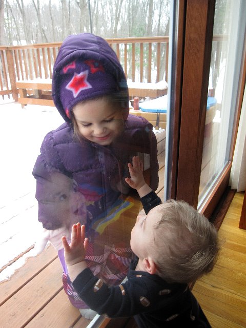 IMG_2884b.jpg - Catherine wanted to go outside and "shovel".  She was slightly disappointed when realizing it had all turned into ice.  Nathan is here trying to get his sister through the slider door.