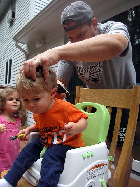IMG_5437b.jpg - This little man is getting his 4th haircut already.  So, we decided to give the Burkett Barbershop a new customer.  Catherine is wondering what in the world is going on .. and if she's next!