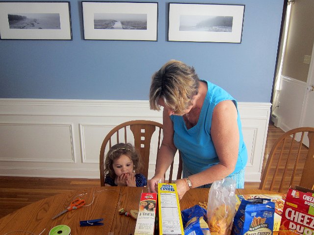 IMG_3478b.jpg - Craft time with Nana ... Catherine is caught eating her snack necklace before it's even completed.