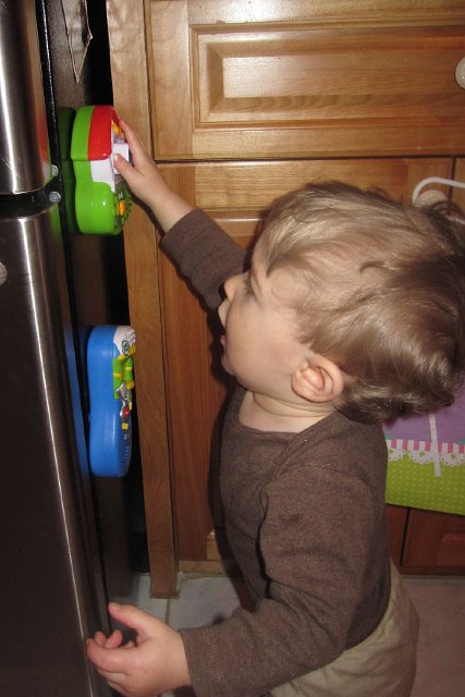 IMG_3854b.jpg - Nathan is already trying to master the fridge phonics toy ... he watches and learns!