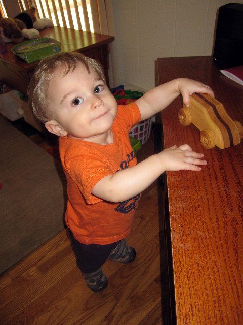 IMG_3904b.jpg - Nathan enjoying a yard sale find .. we just couldn't resist $1 for a wooden car.