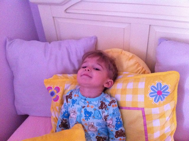 IMG_1846.jpg - Nathan absolutely loves pillows!  Here he is chilling out on his big sister's bed.