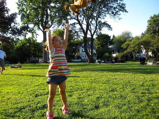 IMG_1050.jpg - Charlie is saying "Weeeeee!" as Catherine tosses him in the air at the Family Music Festival.  Andover Park hosts a different musical group every week and do our best to attend.