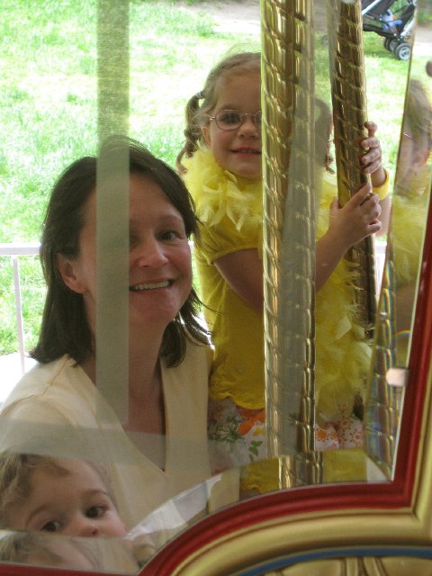 IMG_9566.jpg - We certainly could not leave without riding the merry-go-round!  (Our photo taken using the mirror on the carousel.)