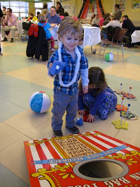 IMG_4874.jpg - A bean bag toss game is most definitely on this kid's wish list.  And, he's very good at it too!