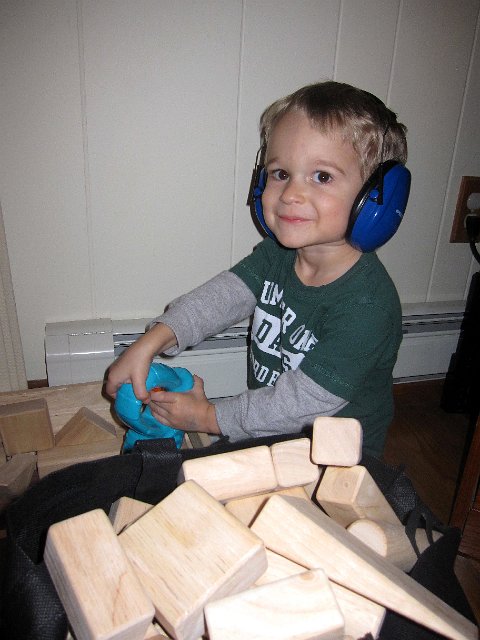 IMG_3751.jpg - Nathan is putting his ear protection to good use when using his drill on these wooden blocks.