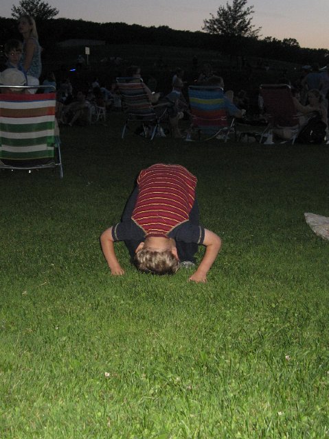 IMG_7057.jpg - Nathan doing forward rolls to pass the time while Catherine practiced a cheer.