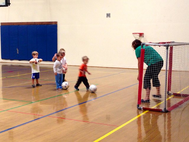 IMG_4389.jpg - Nathan learning some soccer skills at the Y.  (He's the orange blur in front.)