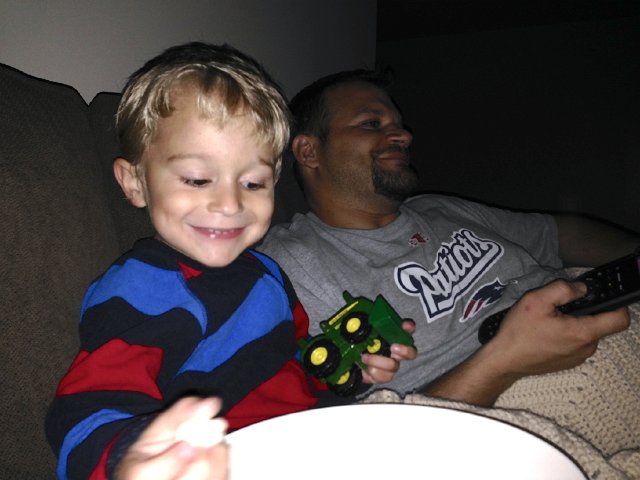 IMG_4511.jpg - Our first family movie night in the basement.  Nathan is a happy camper with a large bowl of popcorn on his lap.