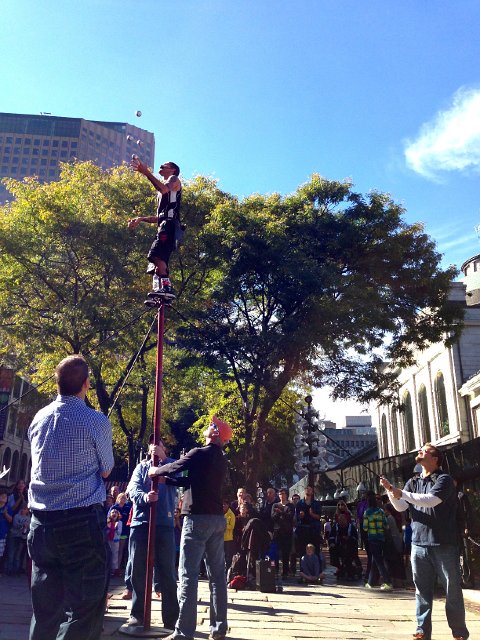 IMG_4711.jpg - There was also a Street Performers Festival going on.  Michael was lucky enough to be volunteered to help with this act.  He is shown here supporting the performer while juggling in the air.