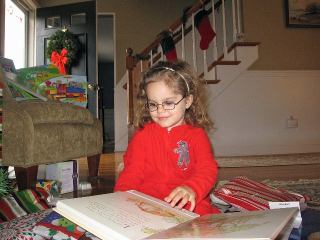 IMG_7634.jpg - Catherine listening to one of her favorite books, Guess How Much I Love You, recorded by Grandpa.