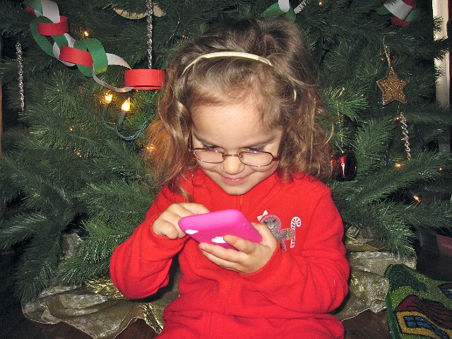 IMG_7693.jpg - Catherine with her requested "pink present".  All she wanted was a pink present, luckily Santa got her a pink case for her new iPod.