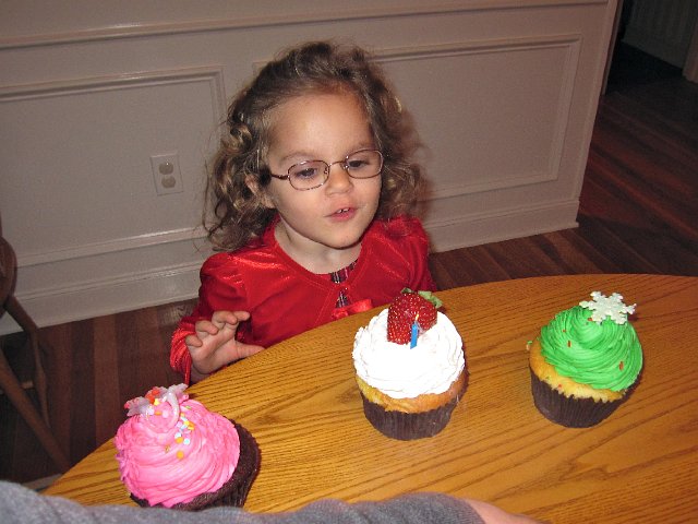 IMG_7784.jpg - Singing Happy Birthday to Jesus.  All month long Catherine was stating how she's getting a chocolate cupcake for Jesus' birthday and He can have strawberry.