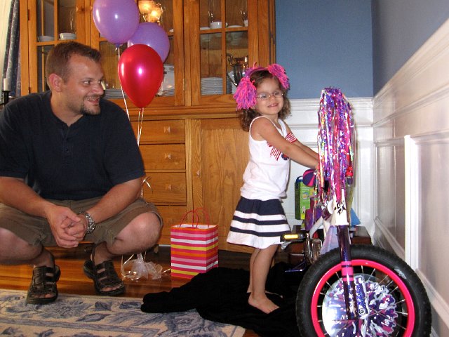 IMG_0779.jpg - Catherine's first bicycle (with training wheels of course).