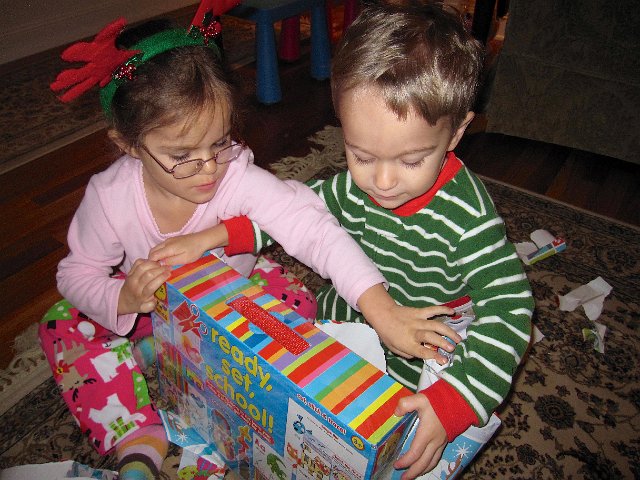 IMG_3399.jpg - We tackle the gifts under the tree next.  This one is to both kiddos from Grandmum & Grandpop.  It may actually be a gift for Mom to have some organized activities to keep these two busy and learning!